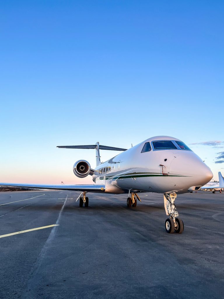 Large-cabin business jet on the apron at sunset