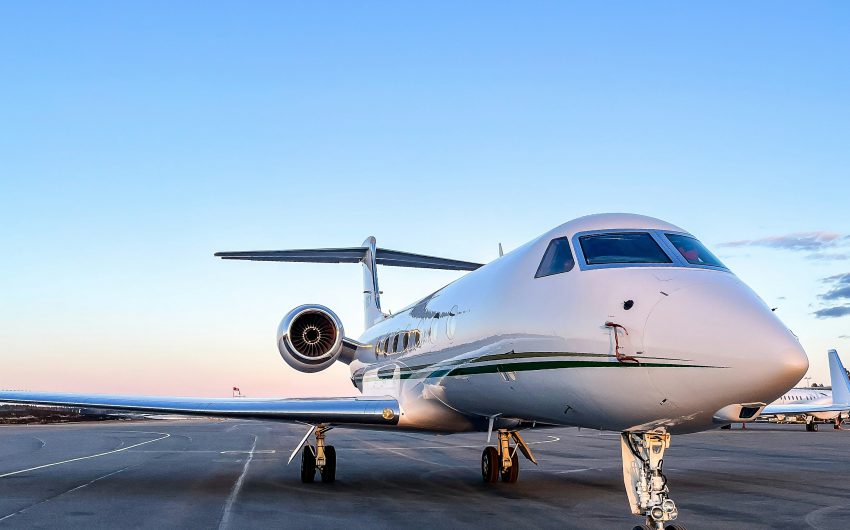 Large-cabin business jet on the apron at sunset